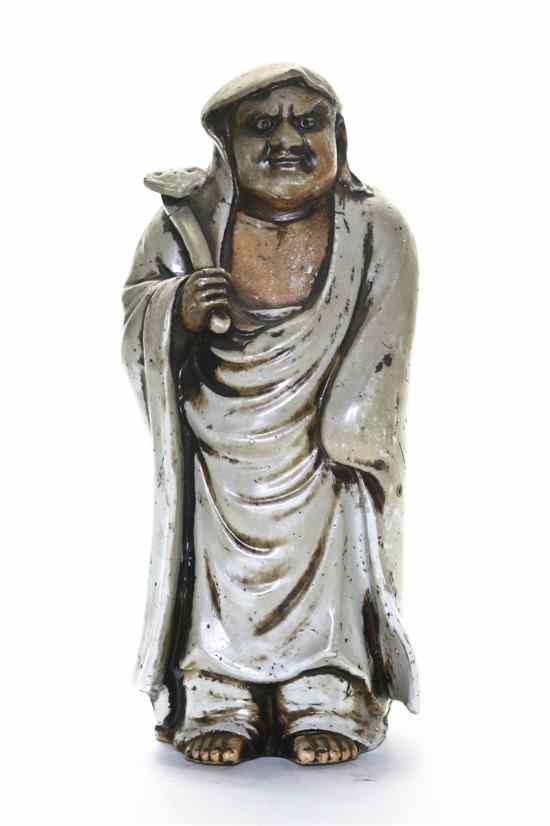 Appraisal: A Shiwan Clay Figure of a Daoist Immortal depicting a