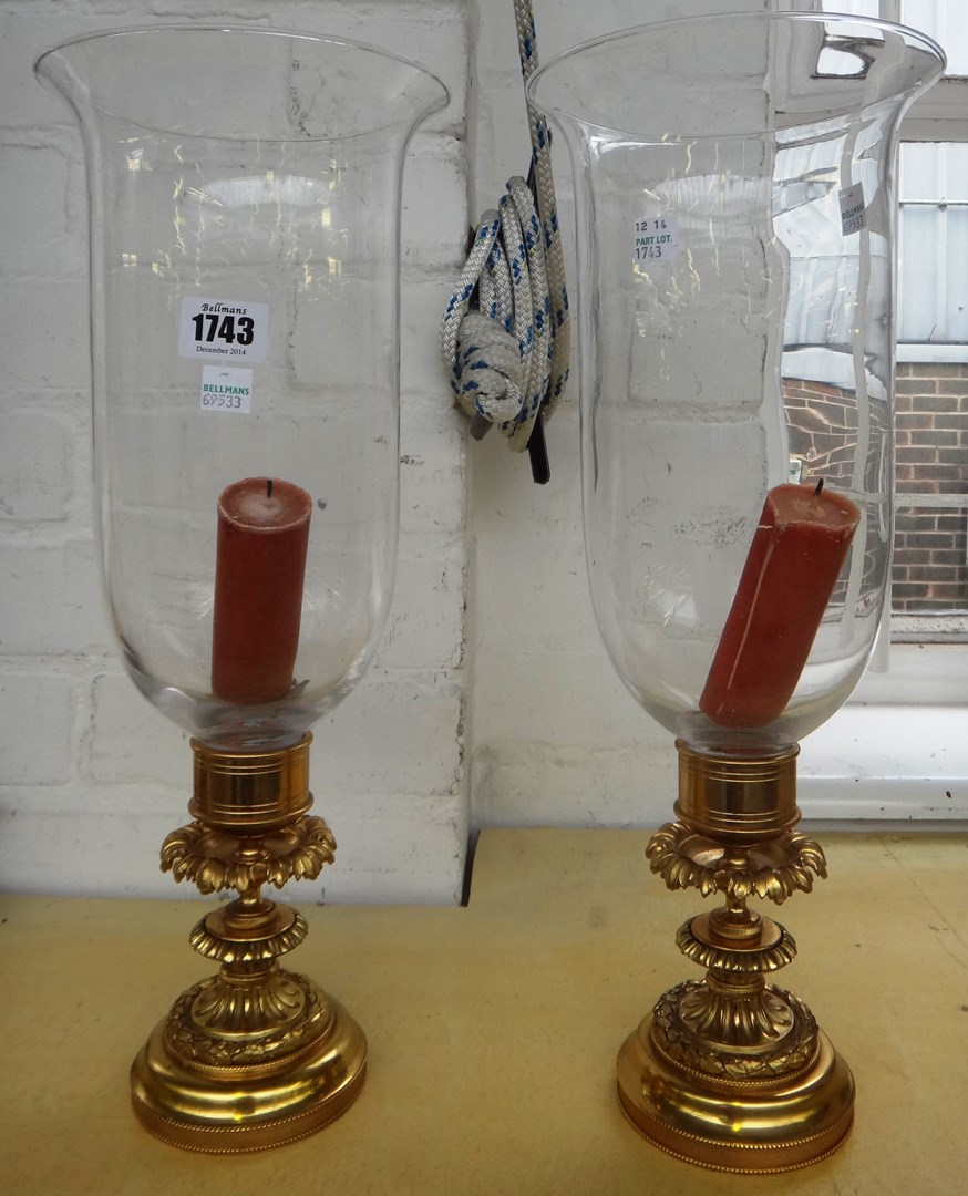 Appraisal: A pair of Regency style ormolu hurricane lamps th century