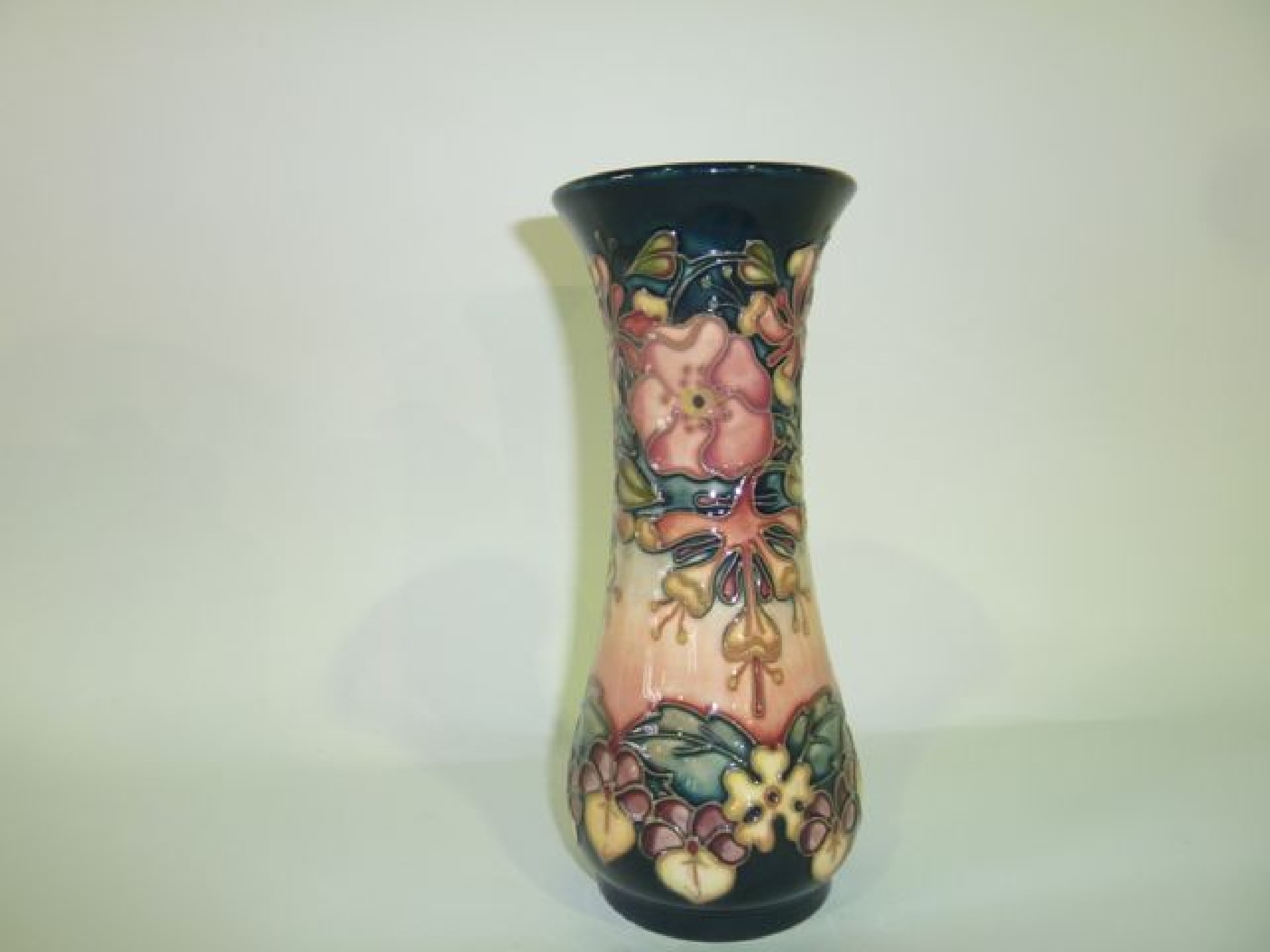 Appraisal: A Moorcroft vase with honeysuckle and dog rose decoration on