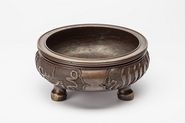 Appraisal: A CHINESE BRONZE CENSER the exterior with three panels of