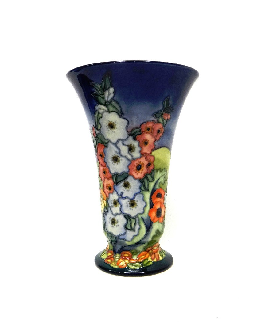 Appraisal: A Moorcroft 'Hollyhock' tapering vase limited edition blue ground cm