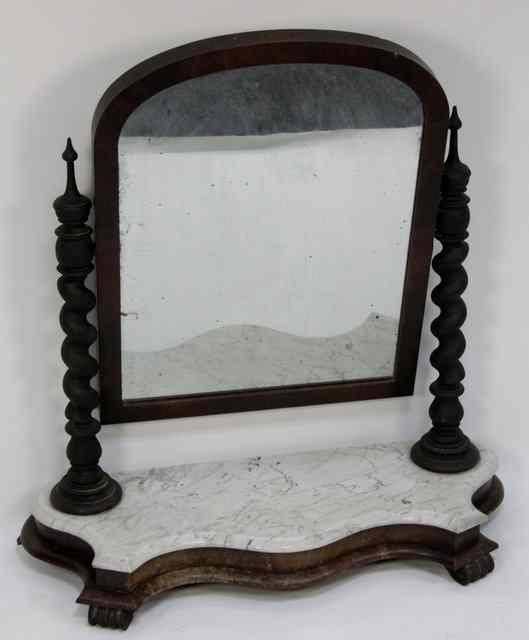 Appraisal: A Victorian swing frame mirror with barley twist supports on