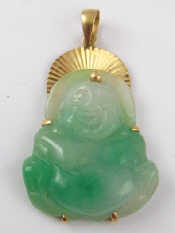 Appraisal: A Chinese carved jade Buddha pendant with yellow metal tests