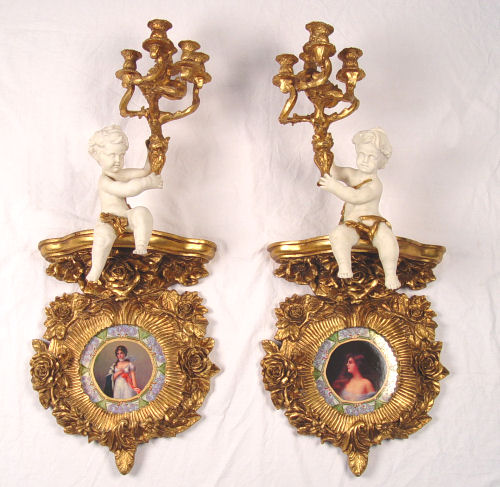 Appraisal: PAIR OF DECORATIVE CHERUB CANDELABRA BRACKET SCONCES Carved giltwood sconces