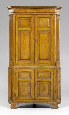 Appraisal: Grain-painted paneled corner cupboard pine throughout with ocher grain-painted surface