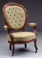 Appraisal: CARVED WALNUT VICTORIAN OPEN ARM CHAIR Carved fruit crest with