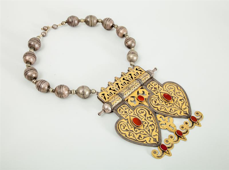 Appraisal: KURDISH GILT-METAL INLAID AND HARDSTONE MOUNTED SILVERED METAL NECKLACE Formed