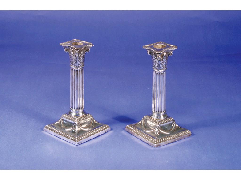 Appraisal: A PAIR OF VICTORIAN CANDLESTICKS with corinthian columns on square