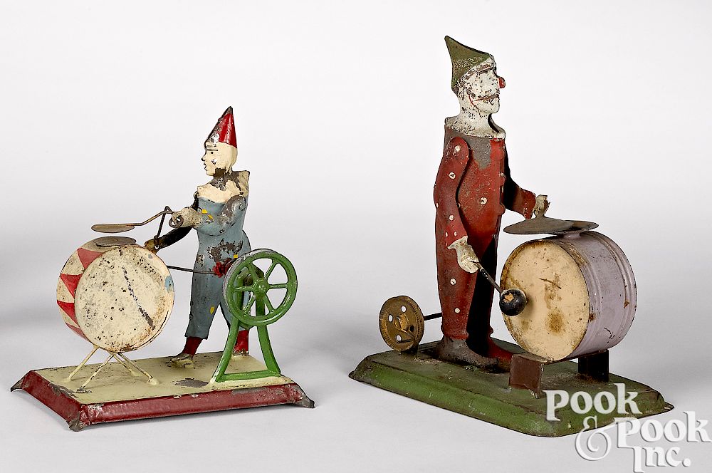 Appraisal: Clowns with drums steam toy accessories Two painted tin clowns