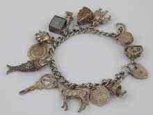 Appraisal: A white metal tests silver charm bracelet with thirteen charms