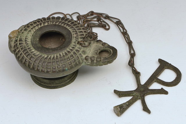 Appraisal: AN EARLY CHRISTIAN BRONZE PEDESTAL OIL LAMP with attached chain