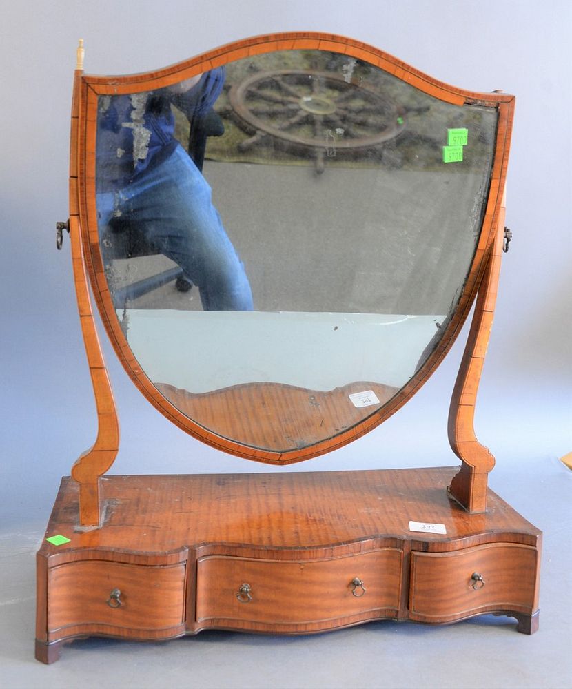 Appraisal: Federal flamed mahogany dressing mirror shield shaped frame over three