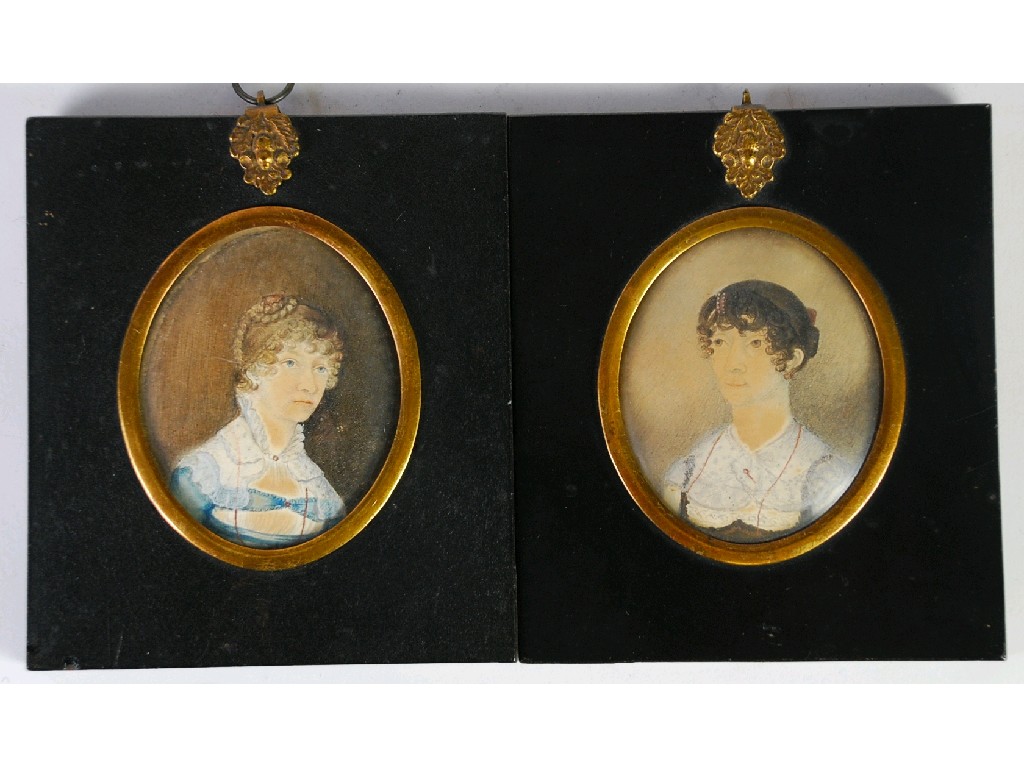 Appraisal: PAIR OF EARLY VICTORIAN OVAL PORTRAIT MINIATURES OF LADIES depicted