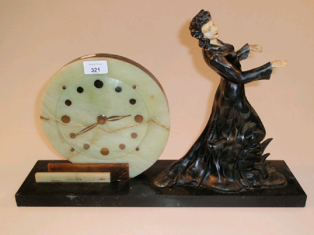 Appraisal: A French Art Deco style mantel clock with circular green