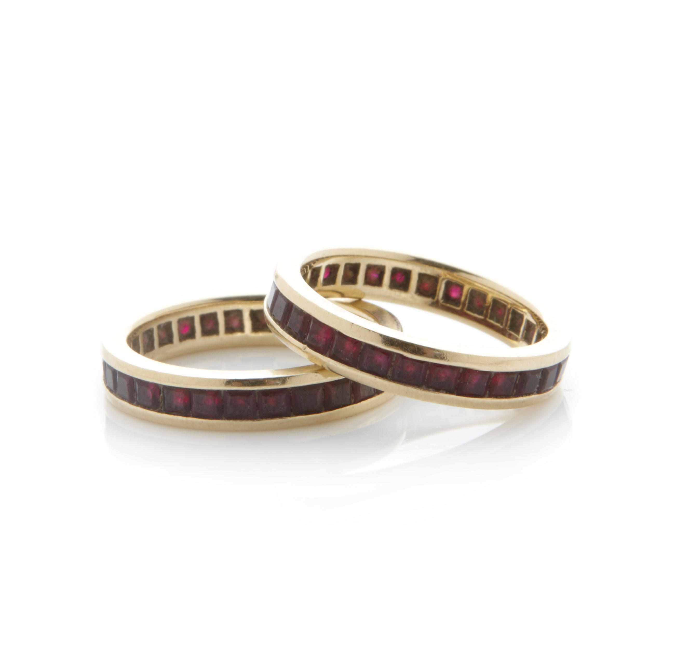 Appraisal: A pair of ruby and gold eternity bands size