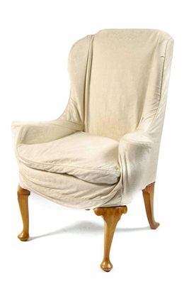 Appraisal: A wing armchair in Queen Anne style with loose covers