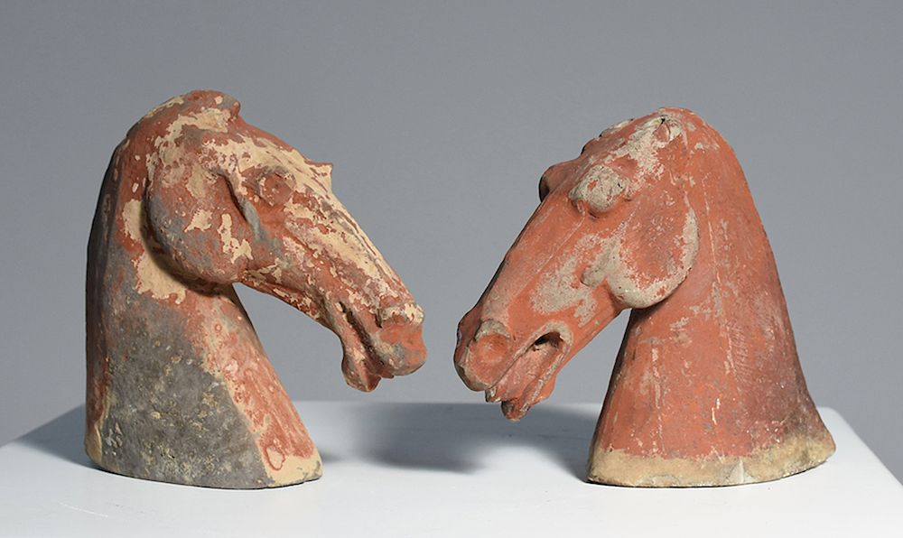 Appraisal: Two Han Dynasty pottery horse heads Two Han Dynasty pottery