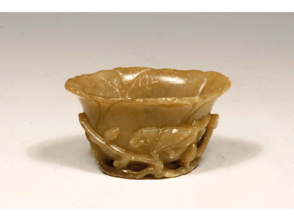 Appraisal: A CHINESE CARVED SOAPSTONE LIBATION CUP with relief carved foliate