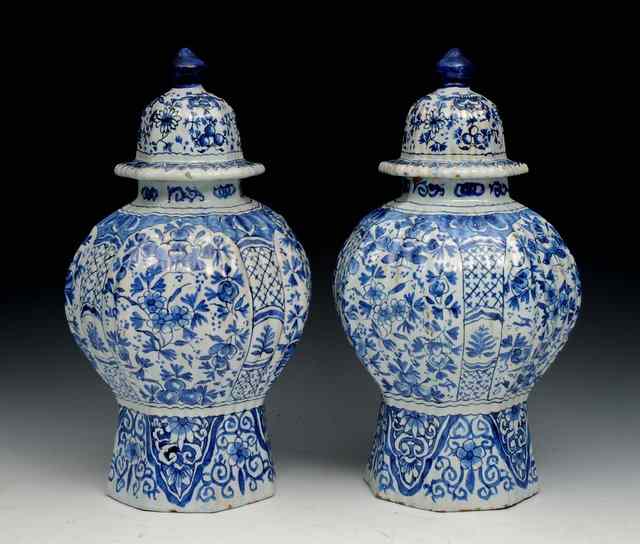 Appraisal: A PAIR OF DELFT BLUE AND WHITE VASES AND COVERS