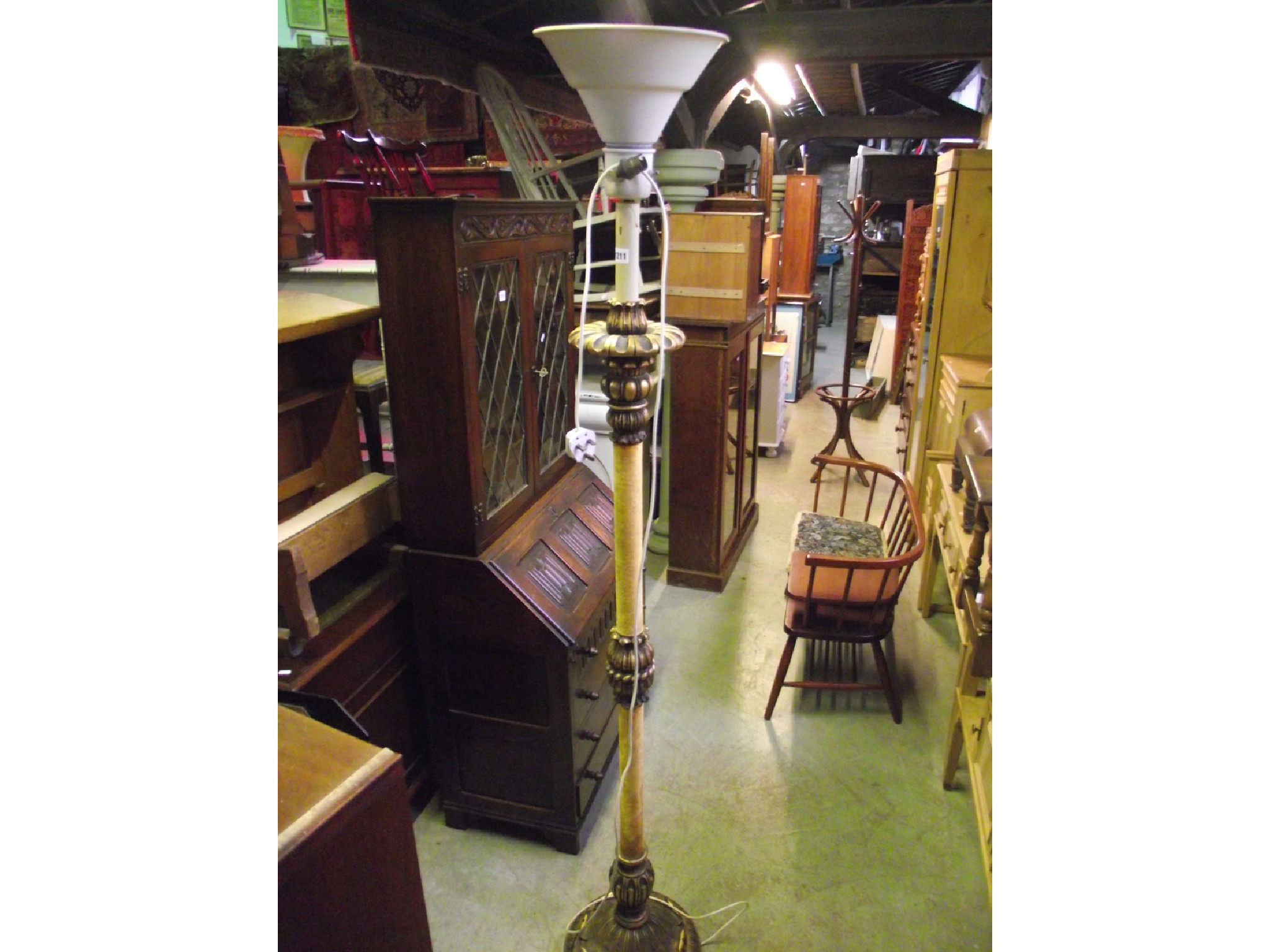 Appraisal: A decorative lampstandard with uplighter shade the partially gilt wood