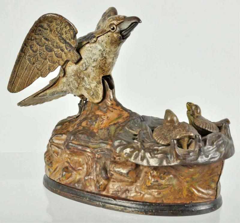 Appraisal: Cast Iron Eagle Eaglettes Mechanical Bank Description Manufactured by J