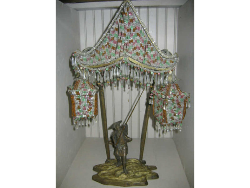 Appraisal: ORIENTALIST BRONZE AND BEADED LAMP Showing an Asian man on