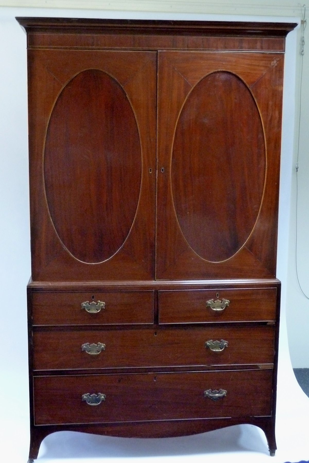 Appraisal: A Regency mahogany linen press the moulded cornice above oval