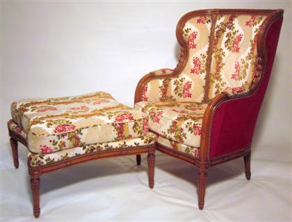 Appraisal: French Louis XVI style carved walnut bergere and ottoman The