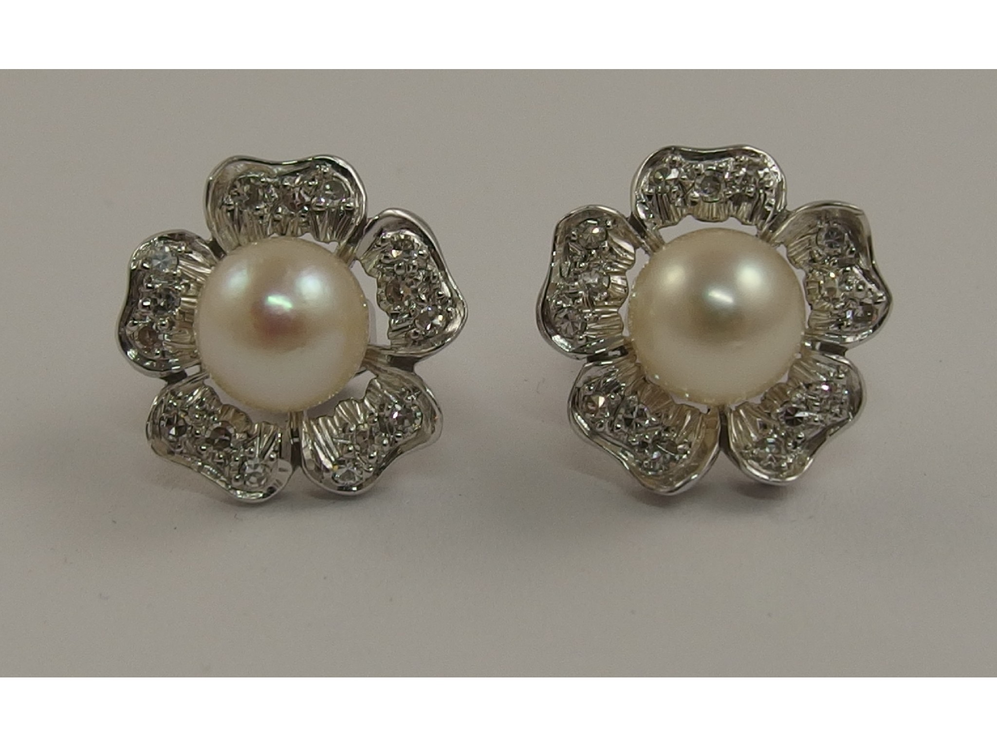 Appraisal: A pair of diamond and pearl flower stud earringsthe open