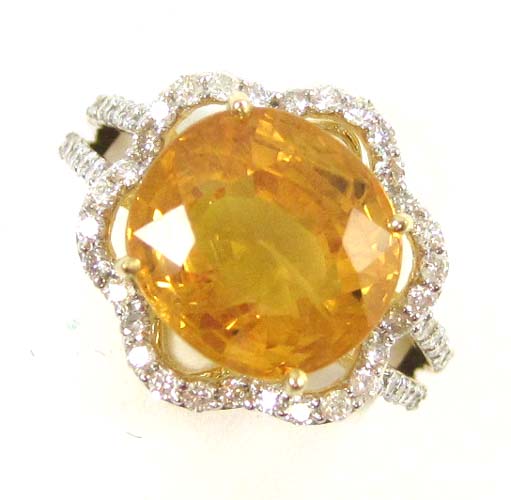 Appraisal: YELLOW SAPPHIRE AND DIAMOND RING k gold with round brilliant-cut