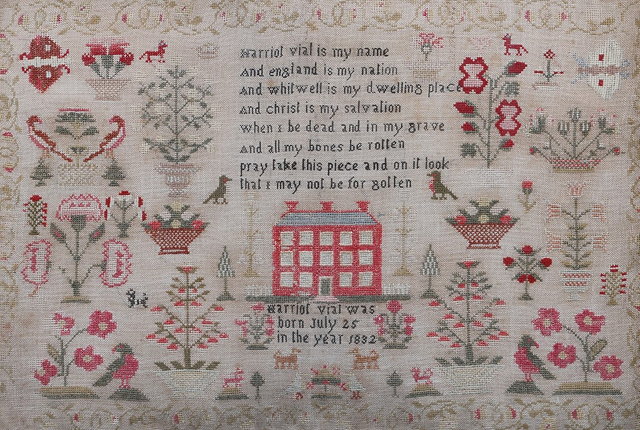 Appraisal: A LARGE NEEDLEWORK SAMPLER with a design of a central