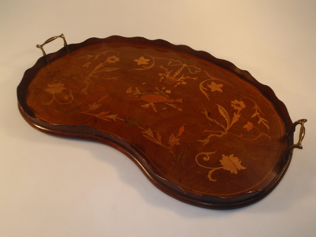 Appraisal: An Edwardian mahogany kidney shaped two-handled tray inlaid with floral