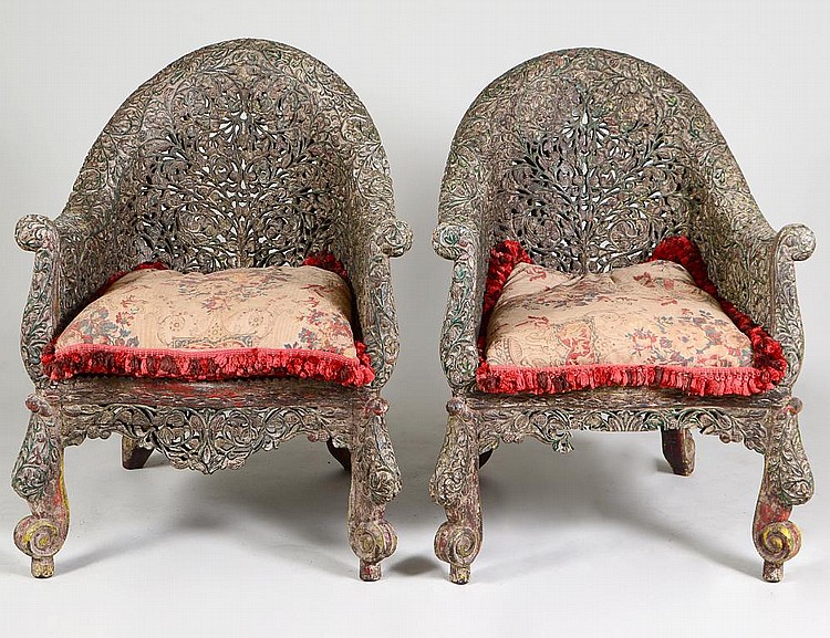 Appraisal: PAIR OF INDIAN CARVED GARDEN CHAIRSCirca The tub shaped backs