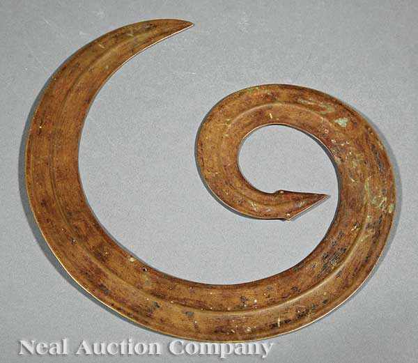 Appraisal: An Antique Indonesian Brass Sangori curled snake form pierced eyes