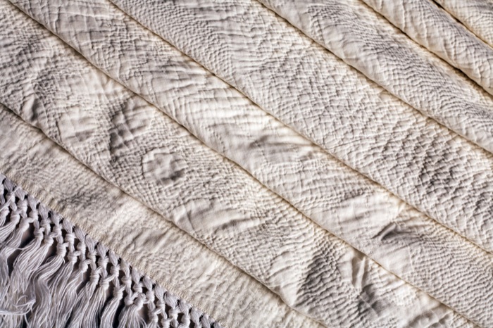 Appraisal: A FINE TRAPUNTO BRIDAL QUILT x inches plus inch fringing