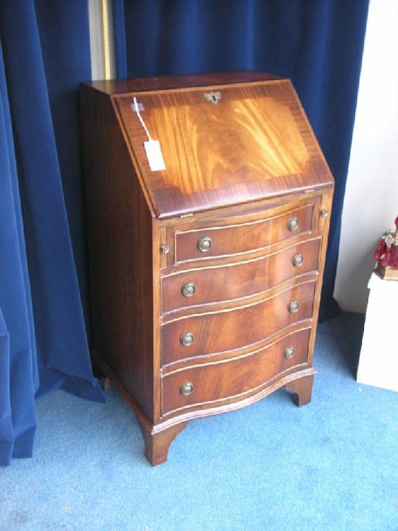 Appraisal: A reproduction mahogany lady's bureau cross-banded fall front enclosing fitted