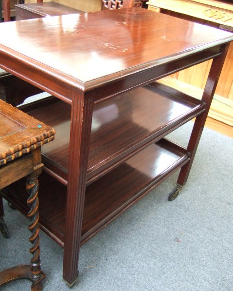 Appraisal: A mahogany standard lamp with turned and fluted column resting