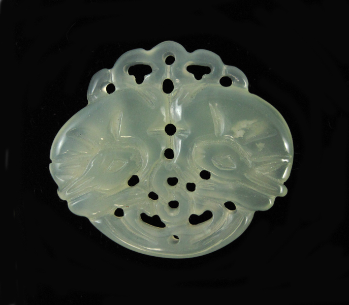 Appraisal: LIGHT GREEN HARDSTONE PENDANT The translucent carving weighs grams and