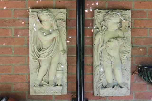 Appraisal: A PAIR OF COMPOSITE WALL PLAQUES with Putti representing two