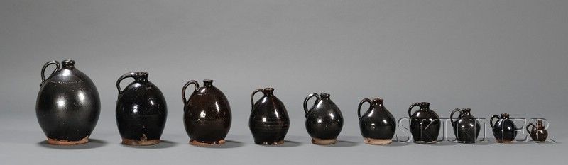 Appraisal: Ten Graduating Black Manganese Glazed Redware Jugs America early th