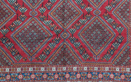 Appraisal: PERSIAN SHIRAZ Area rug with repeating diamond medallion on a