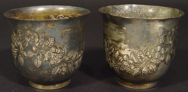 Appraisal: Pair of Victorian silver pots with floral embossed decoration London