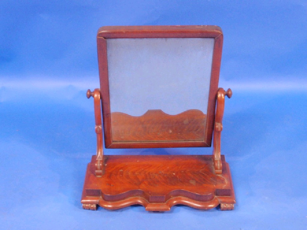 Appraisal: A Victorian figured mahogany rectangular toilet mirror with carved scroll