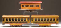 Appraisal: THREE EARLY FRICTION TROLLEY CARS Large wheeled trolley in multi-colored