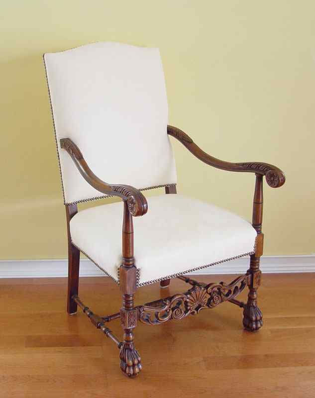 Appraisal: SPANISH STYLE CLAW FOOT ARM CHAIR Scroll arms carved apron