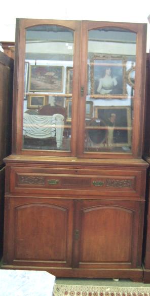 Appraisal: A Victorian walnut framed bookcase cupboard the pair of arch