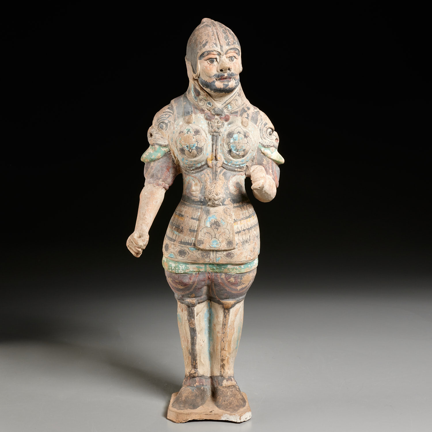 Appraisal: TANG ERA PAINTED POTTERY FIGURE OF A SOLDIER Tang Dynasty