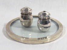 Appraisal: A hallmarked silver salt and pepper on a silver and