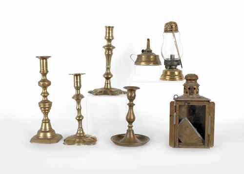 Appraisal: Four brass candlesticks together with a brass skater's lamp and