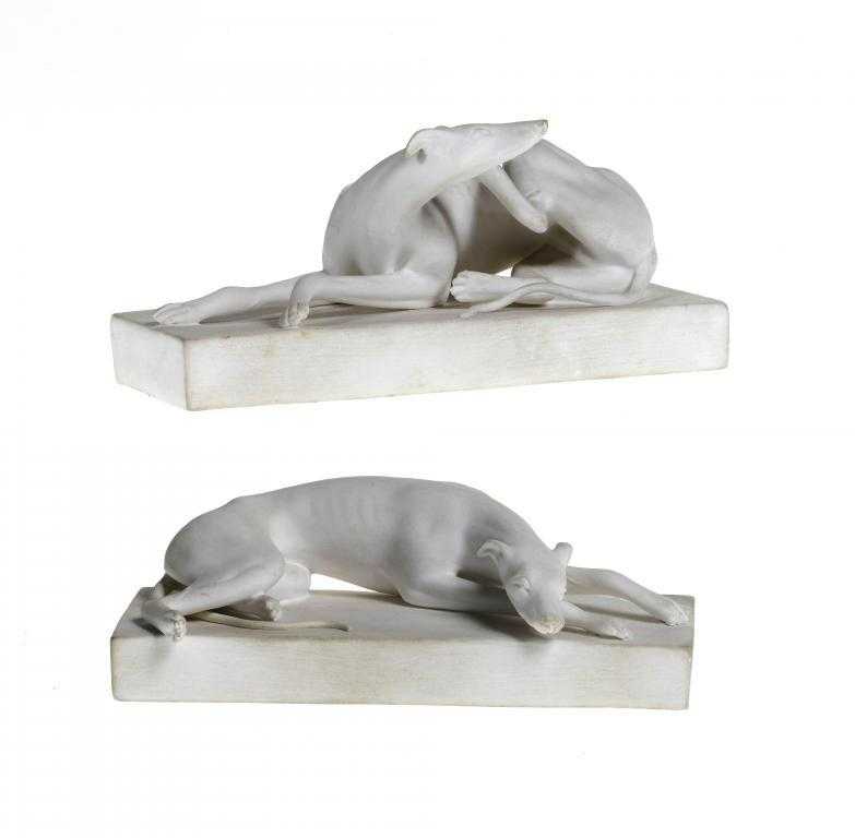 Appraisal: A PAIR OF SAMPSON HANCOCK BISCUIT MODELS OF GREYHOUNDS lying